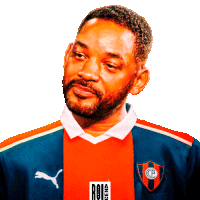 a man with a beard is wearing a red and blue shirt with a puma logo on it