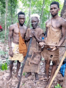 two men and an older woman are posing for a picture