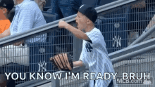 a young boy is holding a baseball glove and screaming at a baseball game while sitting in the stands .