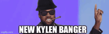 a man wearing sunglasses and a hat is smoking a cigarette and says " new kylen banger "