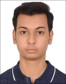 a young man in a blue polo shirt is posing for a picture .