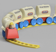 a little tikes toy train with vinyl chloride tankers