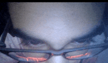 a close up of a person 's face wearing glasses and headphones