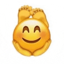 a smiley face with a pair of feet on it 's head .