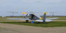 a grey and yellow airplane with the letters o on the wings