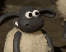 a close up of a cartoon sheep with a surprised look on his face