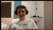 a man wearing headphones and a t-shirt with the word barcelona on it