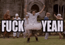 a man in a tutu is dancing in front of a group of people with the words " fuck yeah " above him