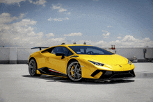 a yellow lamborghini is parked on a parking lot