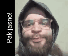 a man with a beard and glasses is wearing a hoodie and glasses .