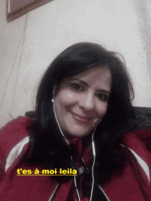 a woman wearing headphones and a red jacket with the words t'es a moi leila above her