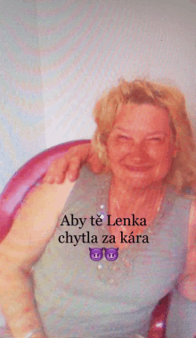 a woman sitting in a chair with her arm around another woman 's shoulder and the words aby te lenka chytla za kara below her