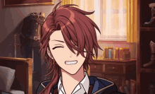 a young man with long red hair is smiling in a bedroom