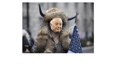 a man wearing a fur coat and horns is holding a flag