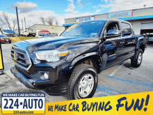 a black truck is parked in front of a lancaster auto dealership