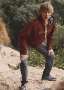 a man wearing a red hoodie with the word patagonia on the front