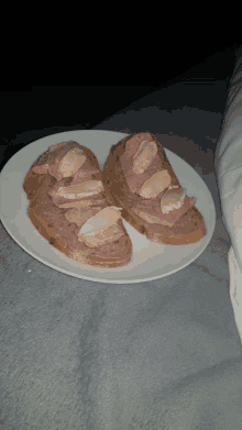 two slices of bread with meat and cheese on a plate