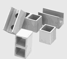 a group of concrete blocks are sitting on top of each other on a white surface .