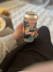 a person is holding a can of vocation special edition