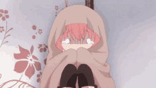 a girl with pink hair is wrapped in a blanket and crying