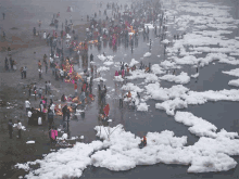 a large group of people gathered in a body of water