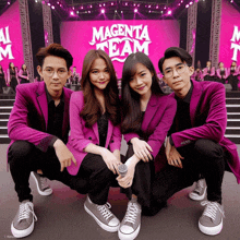 a group of people posing in front of a magenta team banner