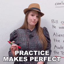 a woman wearing a hat stands in front of a white board with the words practice makes perfect written on it