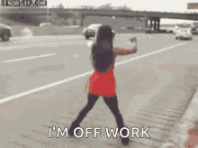 a woman is dancing on the side of a highway with the words `` i 'm off work '' written above her .