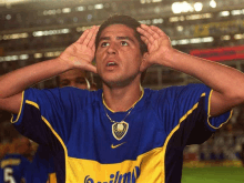 a man wearing a blue and yellow jersey with the word quilmo on it