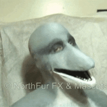 a person wearing a dolphin mask with their mouth wide open