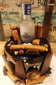 a bottle of magic moments sits on top of a cake