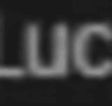 a blurry image of the word luc on a black background