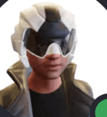 a man wearing a helmet and goggles is looking at the camera .