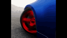 a blue car with a red wheel on it