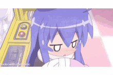 a girl with blue hair is sitting in front of an arcade machine and making a face .