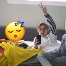 a person laying on a bed with a sleeping emoji and a zzz symbol