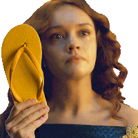 a woman is holding a yellow flip flop over her face