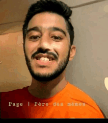 a man with a beard wearing an orange shirt is smiling .