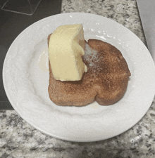 a piece of butter is on a piece of toast