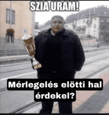 a man holding a trophy with a caption that says ' szia iram '