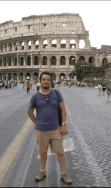 a man stands in front of the colosseum with the letters n on it