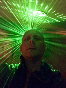 a man stands in front of a green light