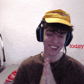 a man wearing headphones and a yellow hat that says lactose on it