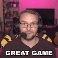 a man wearing headphones and glasses is saying great game .