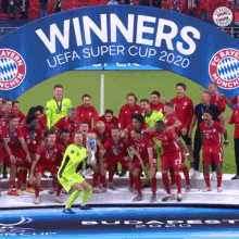 a group of soccer players are posing for a photo under a banner that says winners uefa super cup 2020