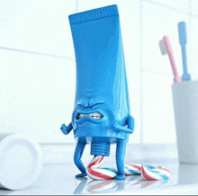 a tube of toothpaste has arms and legs and is holding a tube of toothpaste