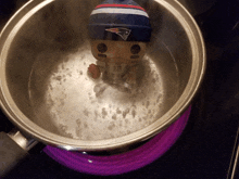 a new england patriots funko pop is being boiled in a pot of water