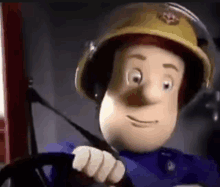 a close up of a cartoon character wearing a helmet driving a fire truck .