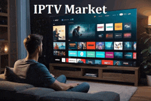 a man is sitting on a couch watching a tv with the words iptv market written above him