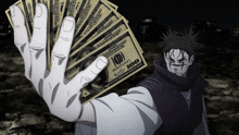 a hand is holding up a stack of 100 dollar bills